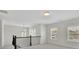Upstairs loft features large windows, plush carpet, and sleek staircase at 399 Tillman Pass, Woodstock, GA 30188