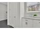 Bright pantry features custom shelving, granite counters, white cabinets, and natural light from the window at 399 Tillman Pass, Woodstock, GA 30188