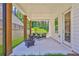 Covered patio features an outdoor seating area and fireplace at 399 Tillman Pass, Woodstock, GA 30188