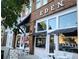 Exterior of EDEN smoothies, juices and bowls, with outdoor seating and American flag at 399 Tillman Pass, Woodstock, GA 30188