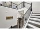 Elegant staircase with dark wood and white risers, leading to the upper level at 399 Tillman Pass, Woodstock, GA 30188