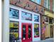 Inviting ice cream shop storefront with bright red doors, window displays, and vintage-style lighting at 399 Tillman Pass, Woodstock, GA 30188