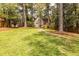 Expansive backyard with lush green lawn and mature trees, enclosed by a wooden fence at 883 Wildwood Ne Rd, Atlanta, GA 30324