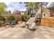 Entertainer's backyard featuring a stone patio with seating, dining area, grill, and easy access to upper deck via stairs at 883 Wildwood Ne Rd, Atlanta, GA 30324