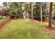 Large backyard with trees, a green lawn, and wood fence creating a private outdoor space at 883 Wildwood Ne Rd, Atlanta, GA 30324