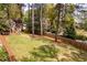 Spacious backyard showcasing a well-kept lawn and wooden fence, and mature trees at 883 Wildwood Ne Rd, Atlanta, GA 30324
