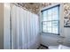 Charming bathroom featuring stylish floral wallpaper and a bright window with blinds at 883 Wildwood Ne Rd, Atlanta, GA 30324
