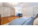 Bright bedroom with hardwood floors, a desk, and a large comfortable bed at 883 Wildwood Ne Rd, Atlanta, GA 30324