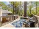 Spacious wooden deck with outdoor seating surrounded by lush greenery at 883 Wildwood Ne Rd, Atlanta, GA 30324