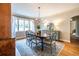Elegant dining room with a chandelier, a large window, and hardwood floors at 883 Wildwood Ne Rd, Atlanta, GA 30324