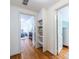 Hallway with hardwood floors, open doorways, and built-in shelving for extra storage at 883 Wildwood Ne Rd, Atlanta, GA 30324