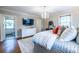Spacious main bedroom with hardwood floors, chandelier, and an en-suite bathroom, blending comfort with convenience at 883 Wildwood Ne Rd, Atlanta, GA 30324