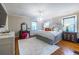 Bright main bedroom with hardwood floors, a chandelier, and ample natural light from the windows at 883 Wildwood Ne Rd, Atlanta, GA 30324