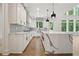 Modern kitchen with island, stainless steel appliances and a scenic backyard view at 3920 Clifton Hill Court #16, Cumming, GA 30040