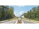 Scenic street view leading to a modern, newly constructed home surrounded by lush trees at 3920 Clifton Hill Court #16, Cumming, GA 30040