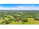 Stunning aerial view features a charming house nestled in a serene, wooded area at 85 Carroll Slough Rd, Kingston, GA 30145