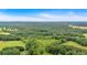 Expansive aerial view showcases the property's lush, green landscape and distant city skyline at 85 Carroll Slough Rd, Kingston, GA 30145