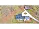 An aerial view captures the architectural layout of this charming farmhouse featuring black metal roof and circular driveway at 85 Carroll Slough Rd, Kingston, GA 30145