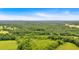 Expansive aerial view showcases the property's lush, green landscape and distant city skyline at 85 Carroll Slough Rd, Kingston, GA 30145