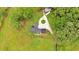 Aerial view of home with circular driveway, lush landscaping, and surrounding greenery at 85 Carroll Slough Rd, Kingston, GA 30145