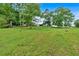 Beautifully maintained backyard with mature trees surrounding the main house at 85 Carroll Slough Rd, Kingston, GA 30145
