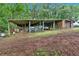 Covered barn for equipment storage, surrounded by lush foliage adding privacy and function to the property at 85 Carroll Slough Rd, Kingston, GA 30145
