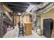 Unfinished basement with exposed beams, stairs, a bar, and mechanical equipment at 85 Carroll Slough Rd, Kingston, GA 30145