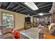 Finished basement area with stone foundation wall, entertainment area, and natural light at 85 Carroll Slough Rd, Kingston, GA 30145