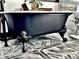 Close up of the luxurious black claw foot tub with elegant details, set on patterned tile flooring at 85 Carroll Slough Rd, Kingston, GA 30145