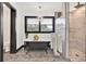 Bright bathroom boasts a clawfoot tub, chandelier, and a glass-enclosed shower with marble tile at 85 Carroll Slough Rd, Kingston, GA 30145