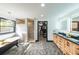 Bright bathroom featuring a clawfoot tub, walk-in shower, double vanity, and entrance to a walk-in closet at 85 Carroll Slough Rd, Kingston, GA 30145