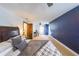 Bedroom with blue accent wall, carpet floors, ceiling fan, and a comfortable bed with pillows and blankets at 85 Carroll Slough Rd, Kingston, GA 30145