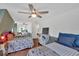 Bedroom with three beds, ceiling fans and wood floors at 85 Carroll Slough Rd, Kingston, GA 30145