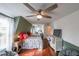 Spacious bedroom with dark wood floors, multiple beds, a ceiling fan, and natural light at 85 Carroll Slough Rd, Kingston, GA 30145