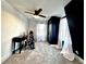 Bedroom featuring neutral carpet, a ceiling fan, a black accent wall, and great natural light from the windows at 85 Carroll Slough Rd, Kingston, GA 30145