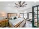 Bright bedroom featuring a decorative fan, windows, and neutral decor at 85 Carroll Slough Rd, Kingston, GA 30145