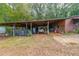 Outdoor carport featuring a wooden structure, ample storage space, and a rustic design at 85 Carroll Slough Rd, Kingston, GA 30145