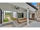 Stylish covered patio with rustic wooden picnic table, ceiling fans, and modern black accents, perfect for outdoor dining at 85 Carroll Slough Rd, Kingston, GA 30145