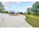 Long driveway leading to a charming home with a three-car garage and screened-in porch at 85 Carroll Slough Rd, Kingston, GA 30145