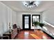 Sunlit entryway with dark trim around door and windows and hardwood floors at 85 Carroll Slough Rd, Kingston, GA 30145