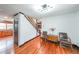 Entryway features wood floors, staircase, and seating arrangement with chairs and a small dresser at 85 Carroll Slough Rd, Kingston, GA 30145