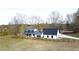 Charming farmhouse with a dark metal roof and white siding, surrounded by a rustic wooden fence at 85 Carroll Slough Rd, Kingston, GA 30145