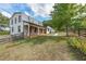 Charming two-story home with stone accents, a metal roof, and a welcoming front porch, surrounded by a fenced yard at 85 Carroll Slough Rd, Kingston, GA 30145