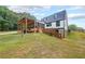 Exterior of a charming home with a screened-in porch and deck overlooking a spacious yard at 85 Carroll Slough Rd, Kingston, GA 30145