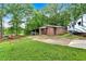 Exterior of home featuring barn, shed, and RV on a lush lot with mature trees at 85 Carroll Slough Rd, Kingston, GA 30145