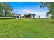 Expansive green lawn leading to a modern farmhouse with a detached two-car garage at 85 Carroll Slough Rd, Kingston, GA 30145