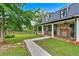 Inviting stone-accented home with a cozy front porch and lush green lawn, perfect for relaxation and outdoor enjoyment at 85 Carroll Slough Rd, Kingston, GA 30145