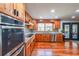 Well-lit kitchen with modern appliances, wooden cabinets and hardwood floors at 85 Carroll Slough Rd, Kingston, GA 30145