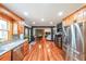 Open concept layout connecting kitchen with stainless steel appliances to the living and dining areas at 85 Carroll Slough Rd, Kingston, GA 30145
