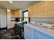 Well-lit laundry room with modern appliances, custom cabinetry, and stylish countertop space at 85 Carroll Slough Rd, Kingston, GA 30145